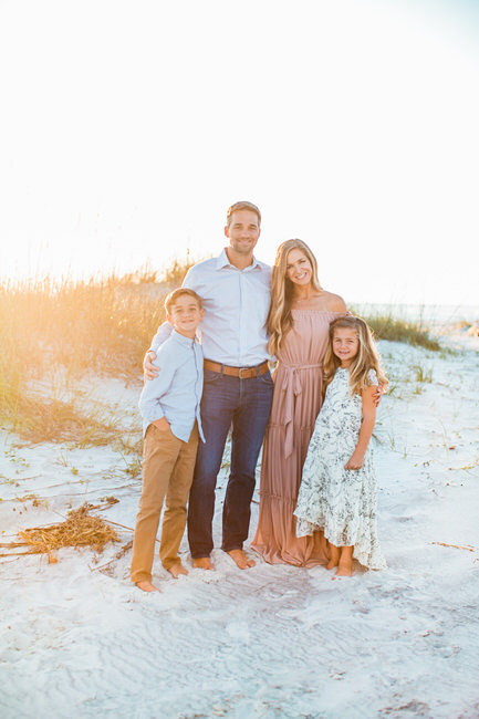 a family poses together at sunset on 30a beach for an alys beach photographer